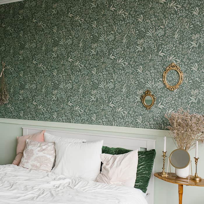 Beautiful floral wallpaper in muted green tones enhancing bedroom ambiance.