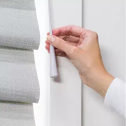 Hand using the UltraGlide wand on Hunter Douglas Vignette Modern Roman Shades