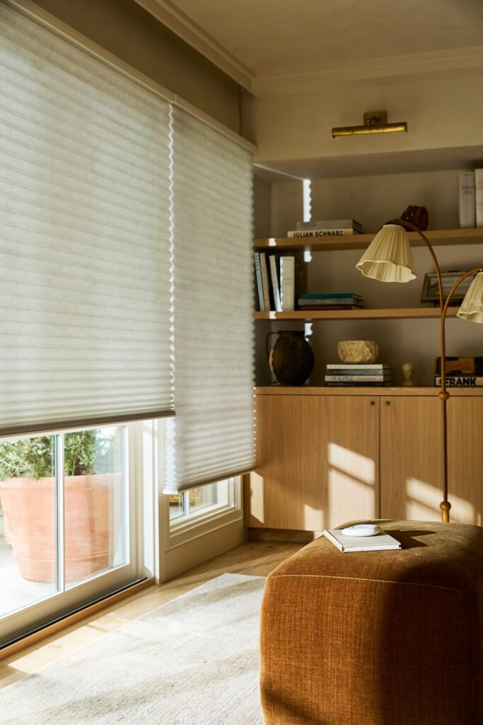 Duette® Honeycomb Shades with PowerView® Automation in a cozy reading corner