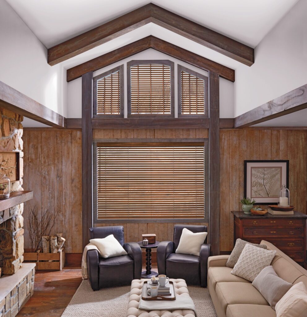 Parkland® Wood Blinds with a cordless lift in a lodge-style living room with a gable window