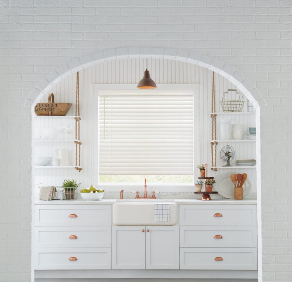 White Parkland® Wood Blinds in basswood on an arched kitchen window